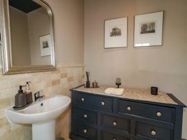 A bathroom with a sink and dresser at Hanowen House in Dungloe, County Donegal