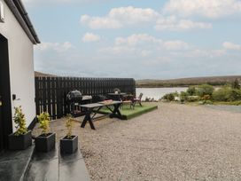 An outdoor area with a grill and table at Hanowen House, Dungloe, County Donegal