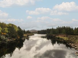 A river with trees and clouds in the background at Hanowen House Dungloe, County Donegal