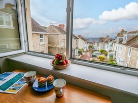 A kitchen with a view of a street and houses at Flat 3