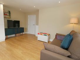 A living room with a television and sofa at Flat 3 