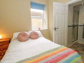 A bedroom with a bed and shower enclosure at Flat 3