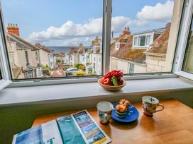 A kitchen with a view of houses and the sea at Flat 3 