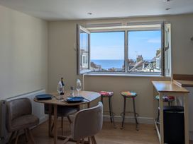 A dining room with a table and chairs at Flat 3 Fortuneswell
