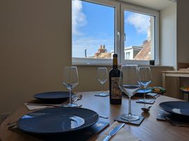 A dining room with a table set for a meal at Flat 3 in Fortuneswell