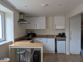 A kitchen with cabinets and appliances at Flat 3 in Fortuneswell