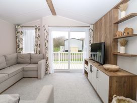 A living room with a sofa and television at Caravan in Great Yarmouth