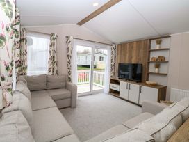 A living room with a sofa and television at Caravan in Great Yarmouth