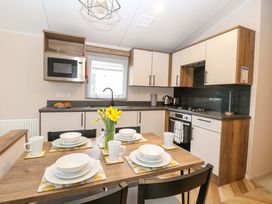 A kitchen with table set for dining at Caravan in Great Yarmouth