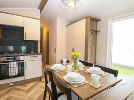 A kitchen with a dining table set for a meal at the Caravan in Great Yarmouth