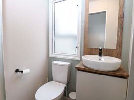 A bathroom with a toilet and sink at Caravan in Great Yarmouth