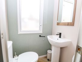A bathroom with a sink and toilet at Caravan in Great Yarmouth