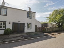 A house with doors and windows beside a fence at Fellfoot Cottage