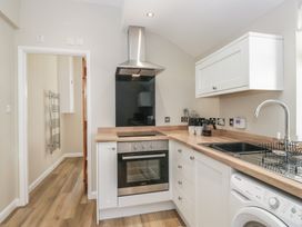 A kitchen with an oven and sink at Fellfoot Cottage
