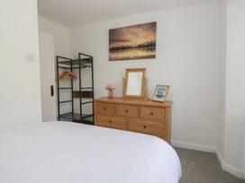A bedroom with a dresser and mirror at Fellfoot Cottage
