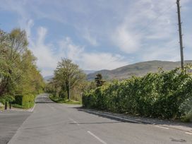 A road with trees and hills on the side at Fellfoot Cottage