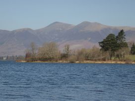 A lake with mountains and trees at Fellfoot Cottage in 