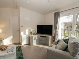 A living room with a television and sofa at The Ridgeway in New Quay