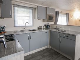 A kitchen with a stove and sink at The Ridgeway in New Quay