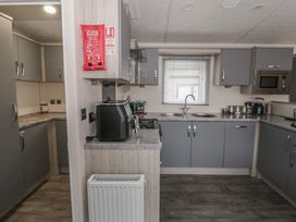 A kitchen with cabinets and appliances at The Ridgeway in New Quay