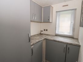 A kitchen with gray cabinets and a countertop at The Ridgeway in New Quay