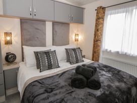 A bedroom with a bed and bedside table at The Ridgeway in New Quay