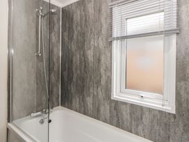 A bathroom with a shower and bathtub at The Ridgeway in New Quay