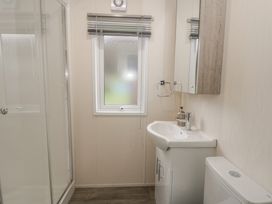 A bathroom with a shower, sink, and toilet at The Ridgeway in New Quay