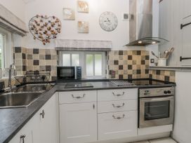 A kitchen with a sink and appliances at The Dove Cot in Ambleside