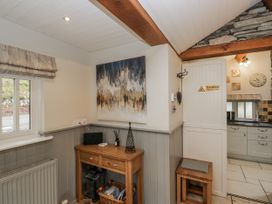 A kitchen with a desk and artwork at The Dove Cot in Ambleside