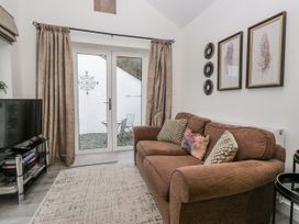 A living room with a sofa and television at The Dove Cot in Ambleside