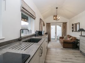 A kitchen with a countertop, sink, and a sofa at The Dove Cot in Ambleside