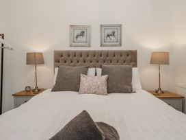 A bedroom with a bed and bedside tables at The Dove Cot in Ambleside
