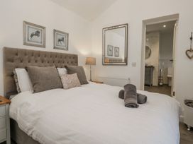 A bedroom with a bed and towels at The Dove Cot in Ambleside