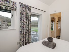 A bedroom with a bed and window at The Dove Cot in Ambleside