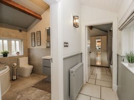 A bathroom with a bathtub and toilet at The Dove Cot in Ambleside