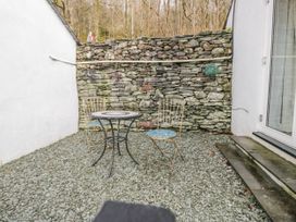 An outdoor area with a table and two chairs at The Dove Cot in Ambleside