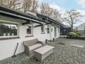 An outdoor area with a bench and table at The Dove Cot in Ambleside