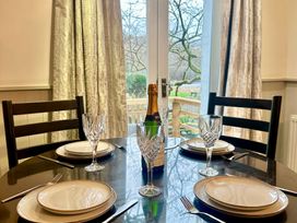 A dining room with a table set for four at The Dove Cot in Clappersgate near Ambleside