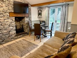 A living room with a sofa and dining area at The Dove Cot in Clappersgate near Ambleside