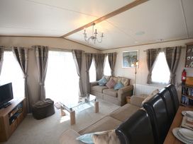 A living room with a sofa and coffee table at 457 Pentreath View in Perranporth