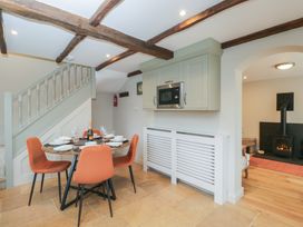 A kitchen with a dining table and staircase at Paddock View Stow-On-The-Wold