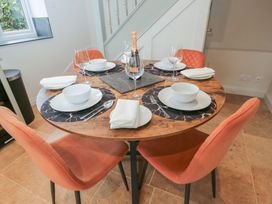 A dining table set with plates and wine glasses at Paddock View Stow-On-The-Wold