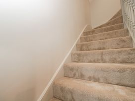 A staircase with carpet and a handrail at Paddock View in Stow-On-The-Wold