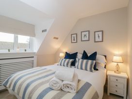 A bedroom with a bed and side table at Paddock View Stow-On-The-Wold