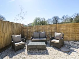 A garden with outdoor seating and a table at Paddock View in Stow-On-The-Wold
