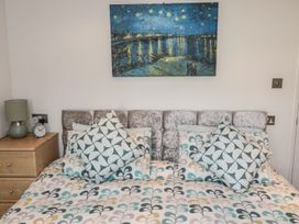 A bedroom with a bed and bedside table at Nevaeh Lodge in Longframlington
