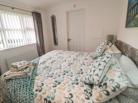 A bedroom with a bed and pillows at Nevaeh Lodge Longframlington