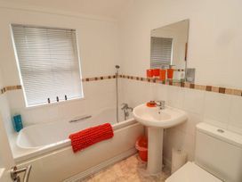 A bathroom with bathtub, sink, and toilet at Nevaeh Lodge Longframlington