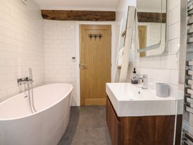 A bathroom with a bathtub and sink at The Old Cartshed | Yr Hen Gwt Cart, Abergele